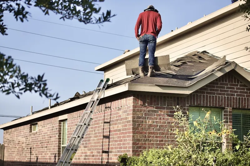 Professional roofer working on a residential roof in Glen Cove Landing